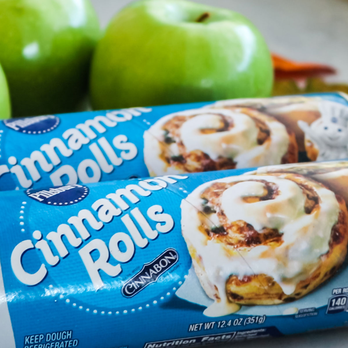Ingredients you will need to make Apple Cinnamon Rolls including Green Apples and Pillsbury Cinnamon Rolls.