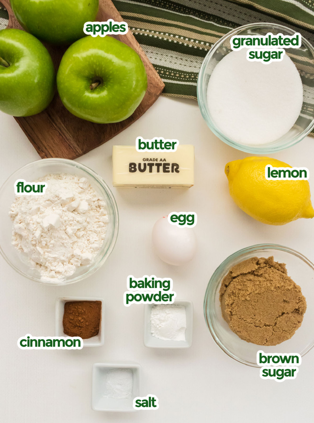 All the ingredients you will need to make Easy Apple Cobbler including apples, sugar, lemon, egg, butter, flour, brown sugar, baking powder, cinnamon and salt.
