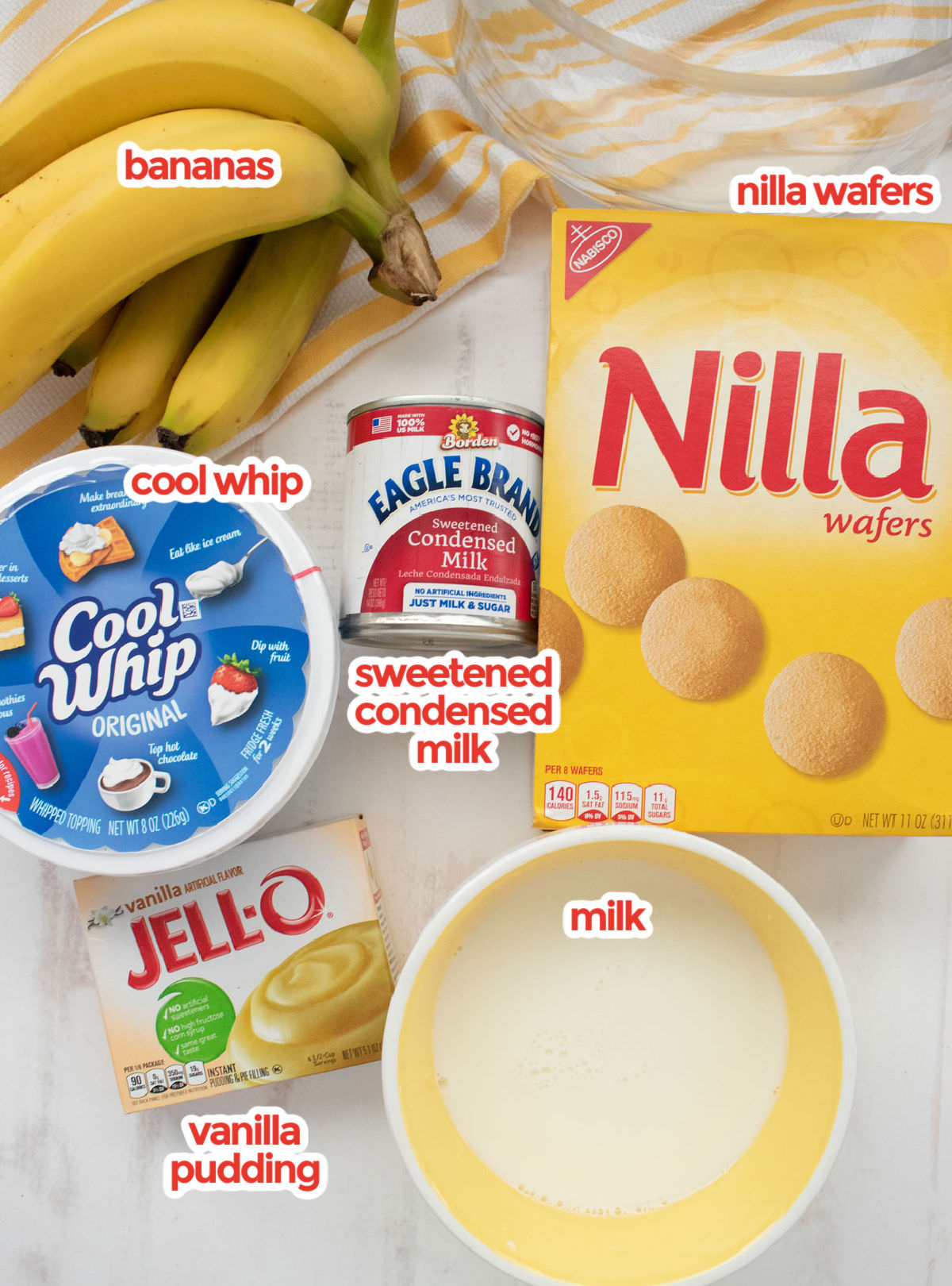 An image showing all the ingredients you will need to make Banana Pudding including Bananas, Nilla Wafers, Sweetened Condensed Milk, Cool Whip, Vanilla Pudding and Milk.