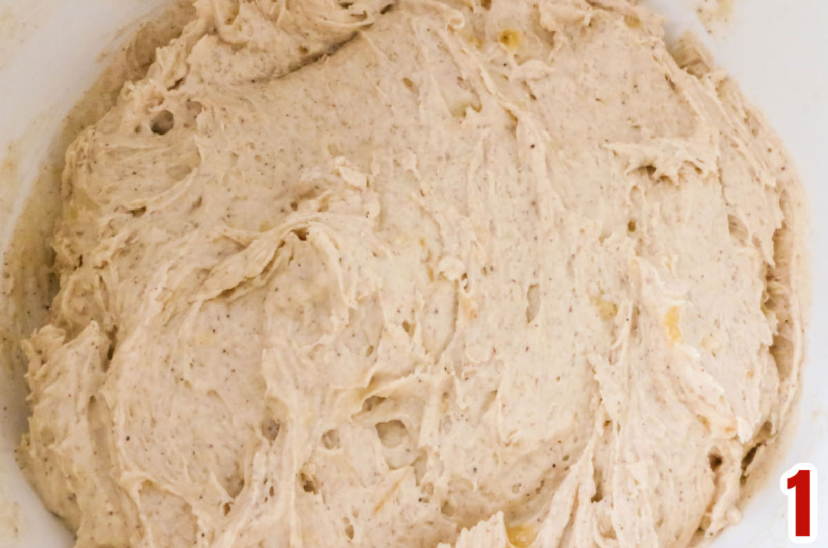 Closeup on a white mixing bowl filled with Banana Cookie dough.