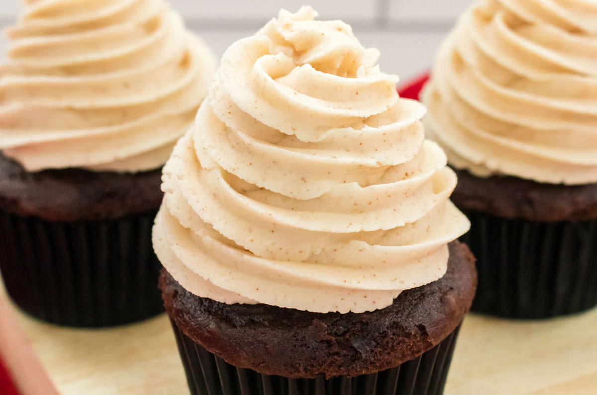 Closeup on three cupcakes topped with The Best Brown Butter Buttercream Frosting.