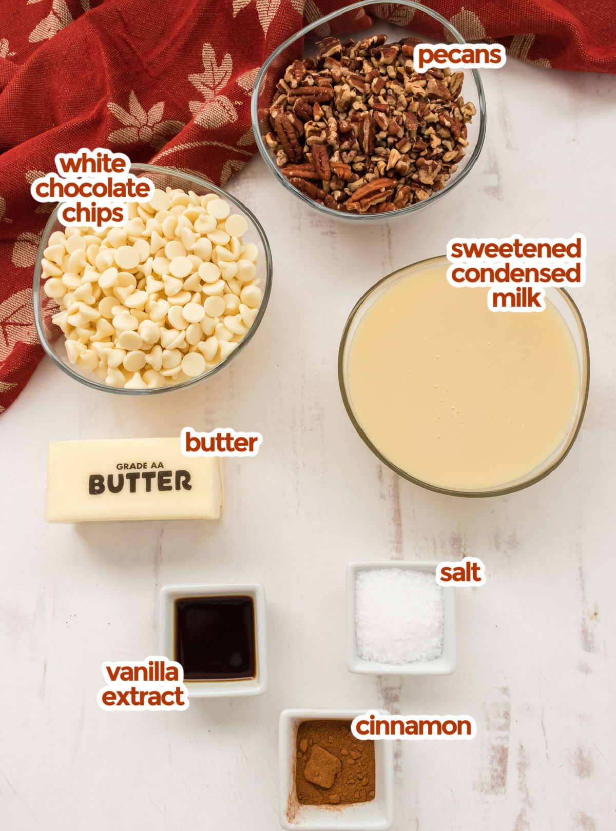 All the ingredients you will need to make Butter Pecan Fudge including pecans, Sweetened Condensed Milk, White Chocolate Chips, Butter, Vanilla, Cinnamon and Salt.