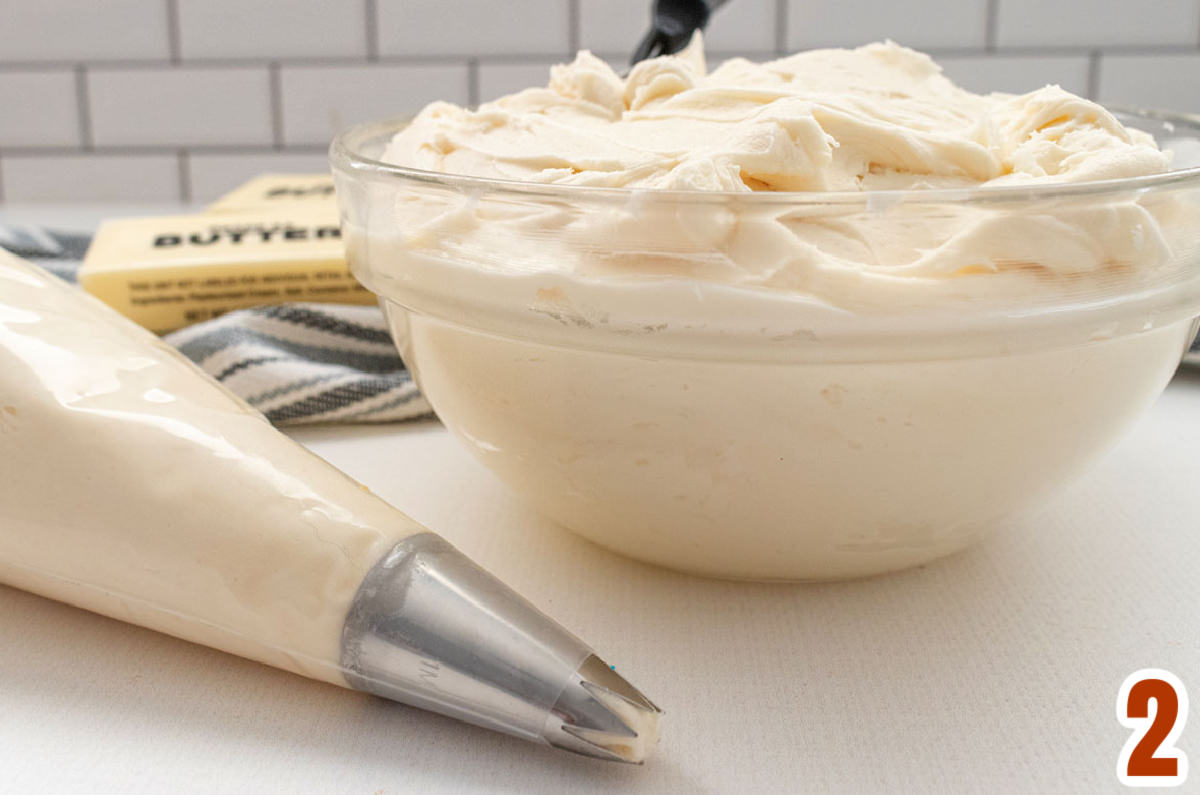 Closeup on a glass bowl filled with homemade Buttercream Frosting.