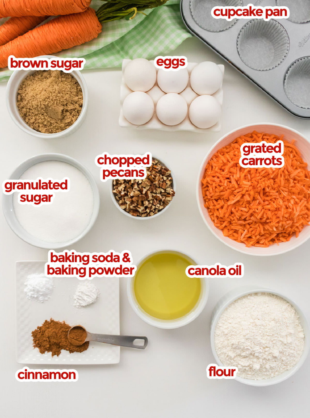 All the ingredients you will need to make Carrot Cake Cupcakes including flour, sugar, brown sugar, carrots, eggs, canola oil, chopped pecans and spices.