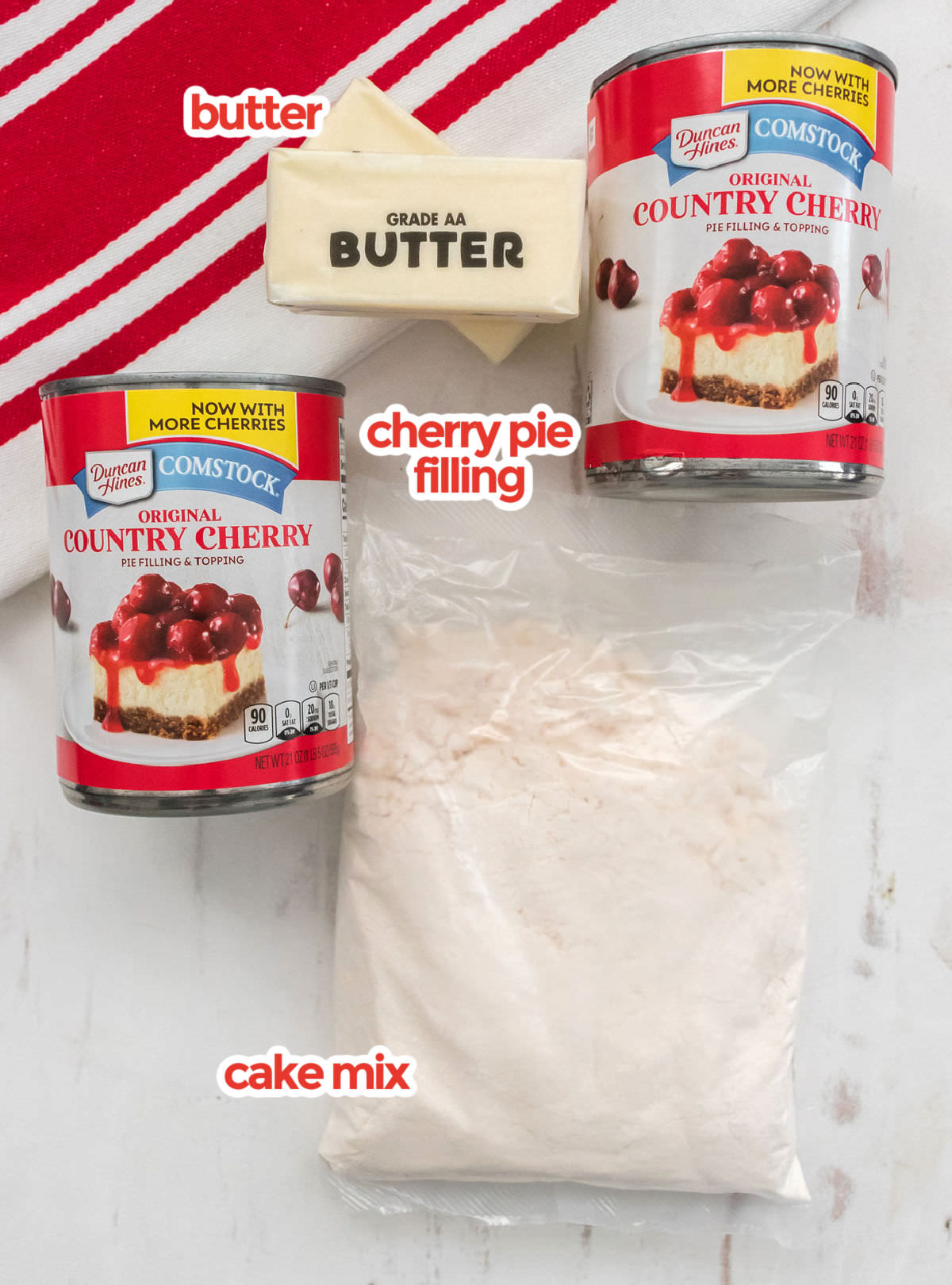 All the ingredients you will need to make a Dump Cake including Butter, Cake Mix and Cherry Pie filing.