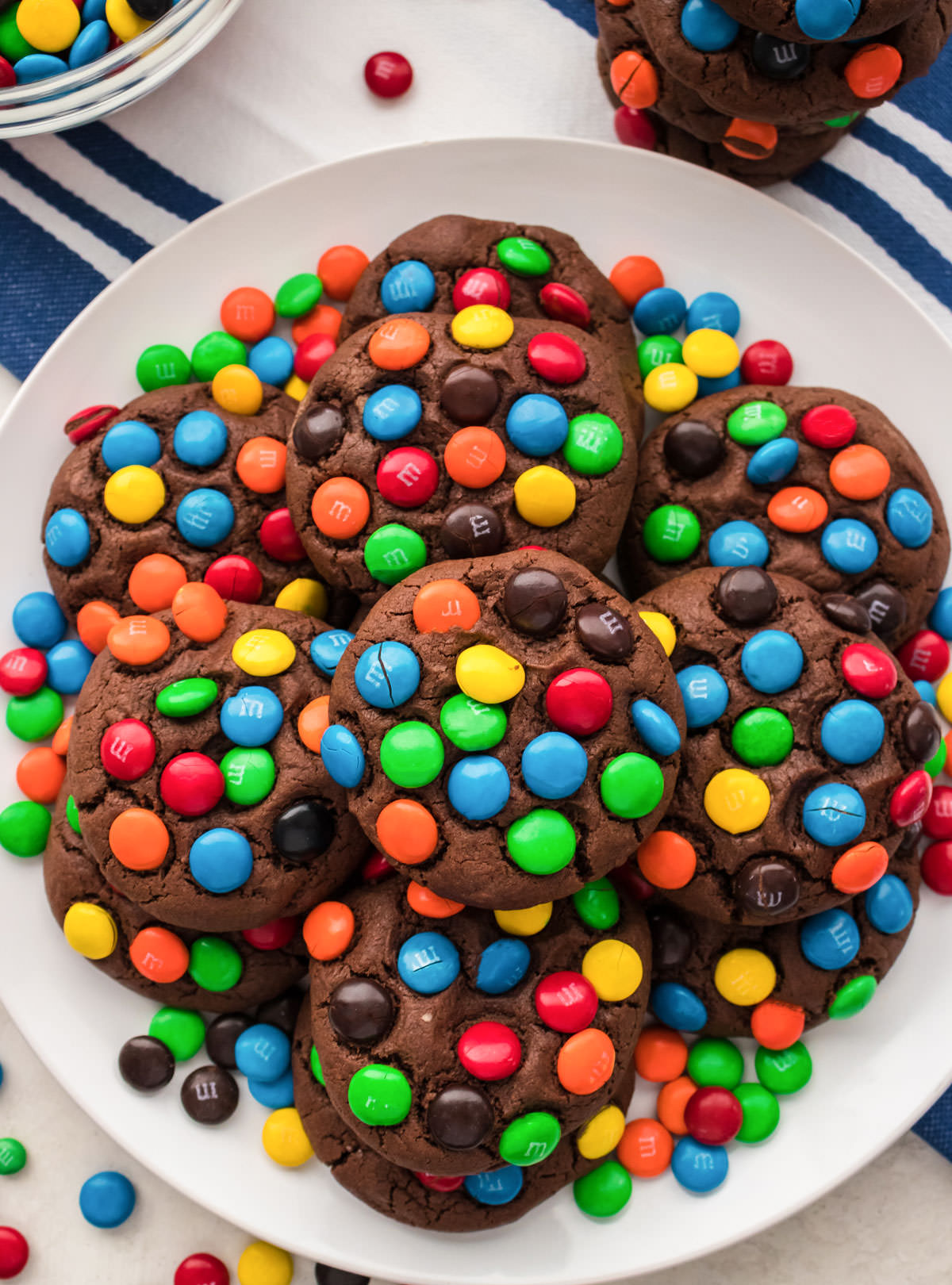 Overhead shot of a white plate filled with Chocolate M&M Cookies.