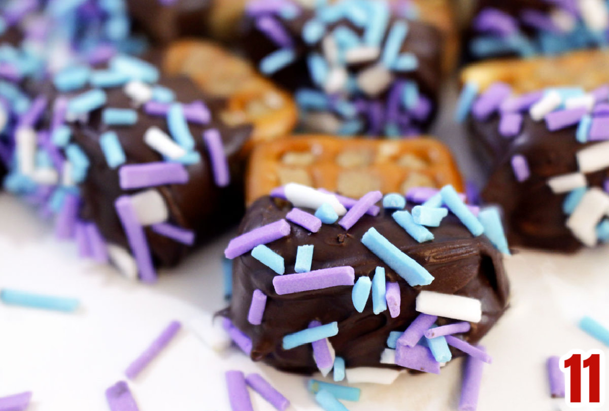Closeup on Chocolate Dipped Peanut Butter Pretzels covered in sprinkles for parties.