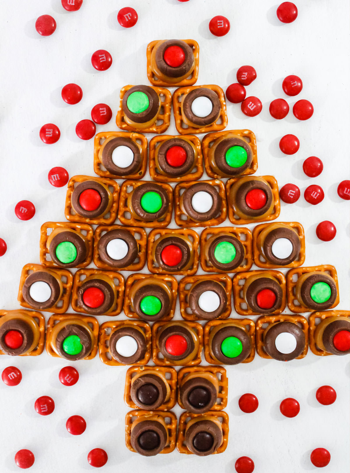 Overhead shot of a batch of Christmas Caramel Pretzel Bites arranged in a Christmas Tree pattern.