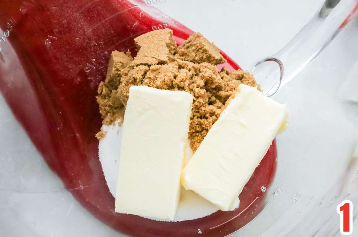 Closeup on butter, granulated sugar and brown sugar in a glass mixing bowl.