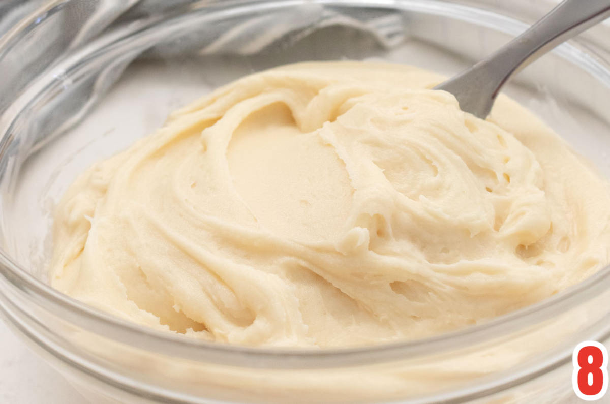 Closeup on a glass bowl filled with homemade Cream Cheese Frosting.