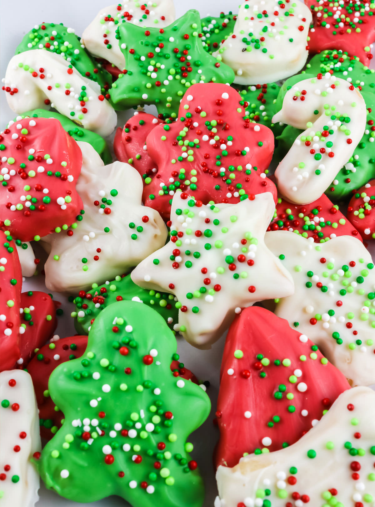 Closeup on a batch of Christmas Circus Animal Cookies sitting on a white platter.