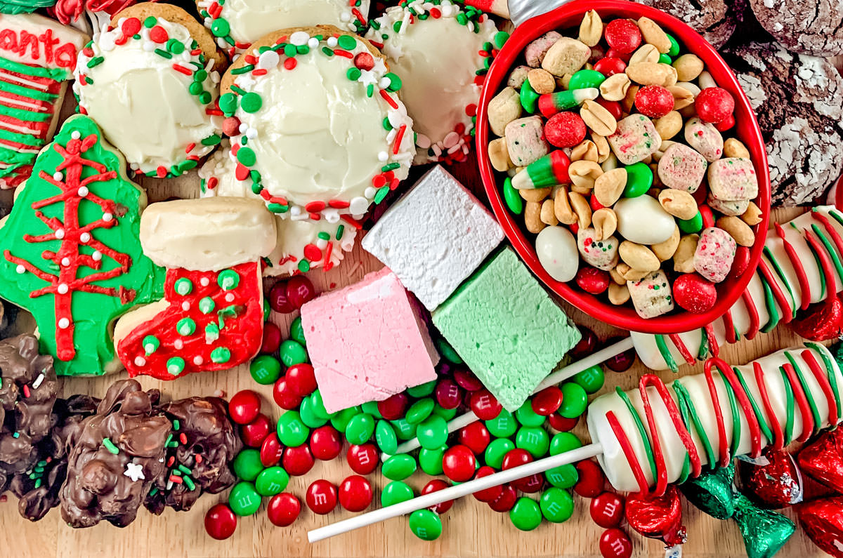 Collection of Christmas Desserts arranged on a large wooden cutting board.