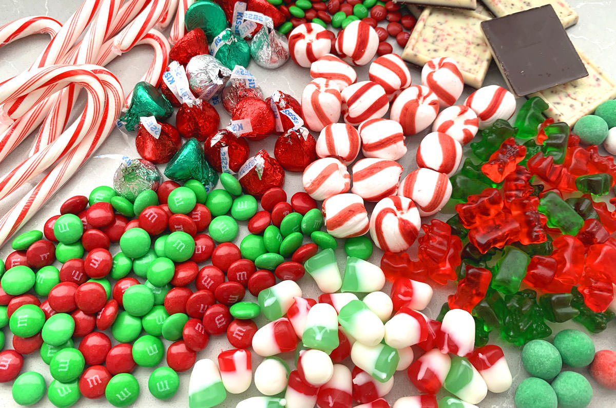 Collection of Christmas Candy arranged on a gray table.