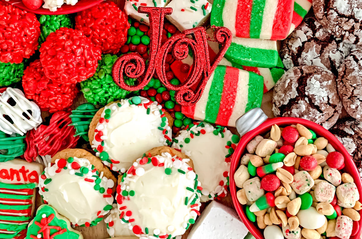 Collection of Christmas Desserts arranged on a large wooden cutting board.