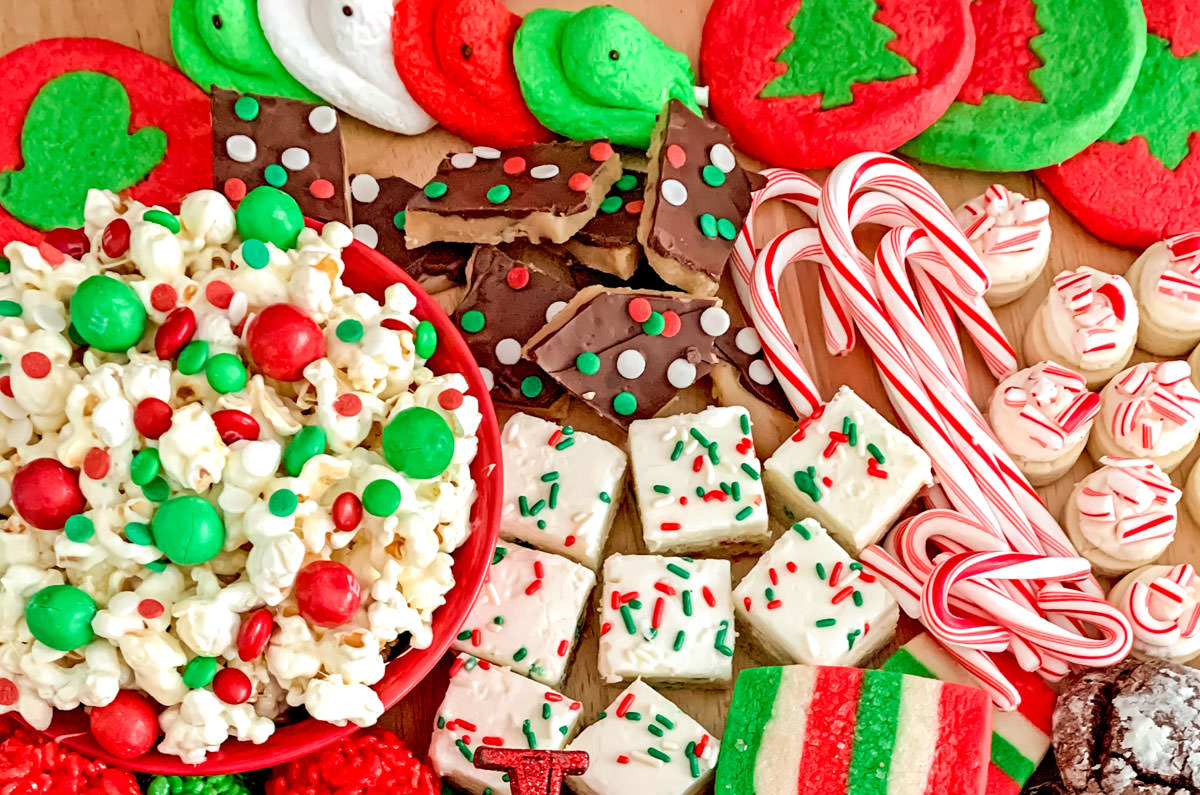 Collection of Christmas Desserts arranged on a large wooden cutting board.