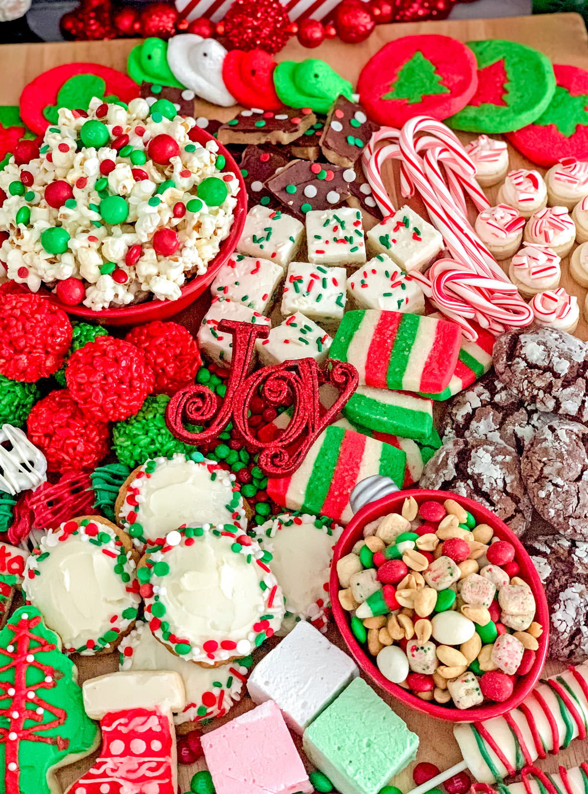 Overhead shot of a Christmas Dessert board filled with Christmas treats, cookies and candies.