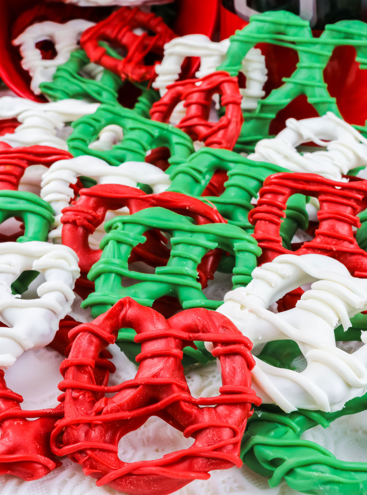 A batch of Christmas Pretzels spilled out on a white surface.