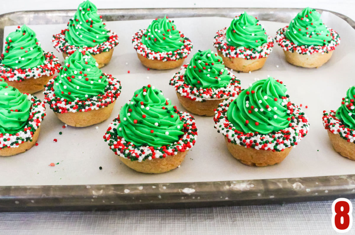 A cookie sheet filled with Christmas Tree Cookie Cups.
