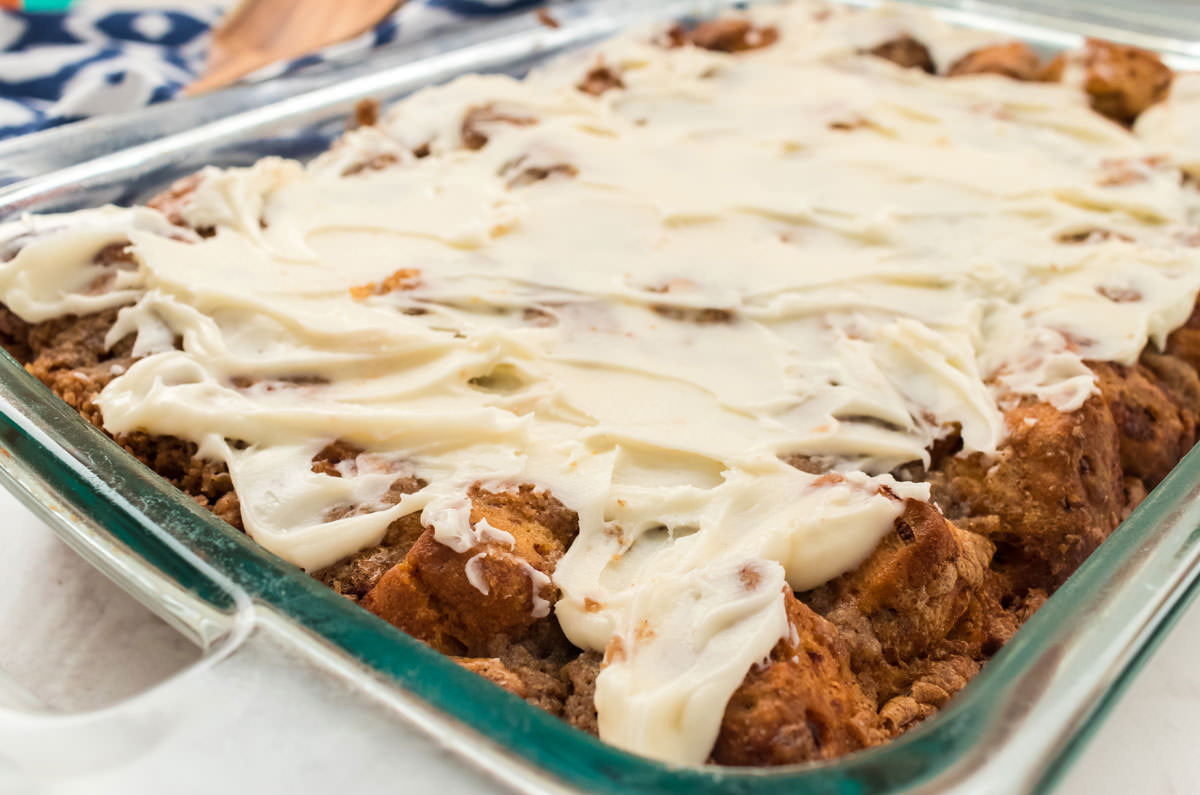 Close up of a pan of Cinnamon Roll Breakfast Casserole covered with a thick layer of Cream Cheese Frosting.