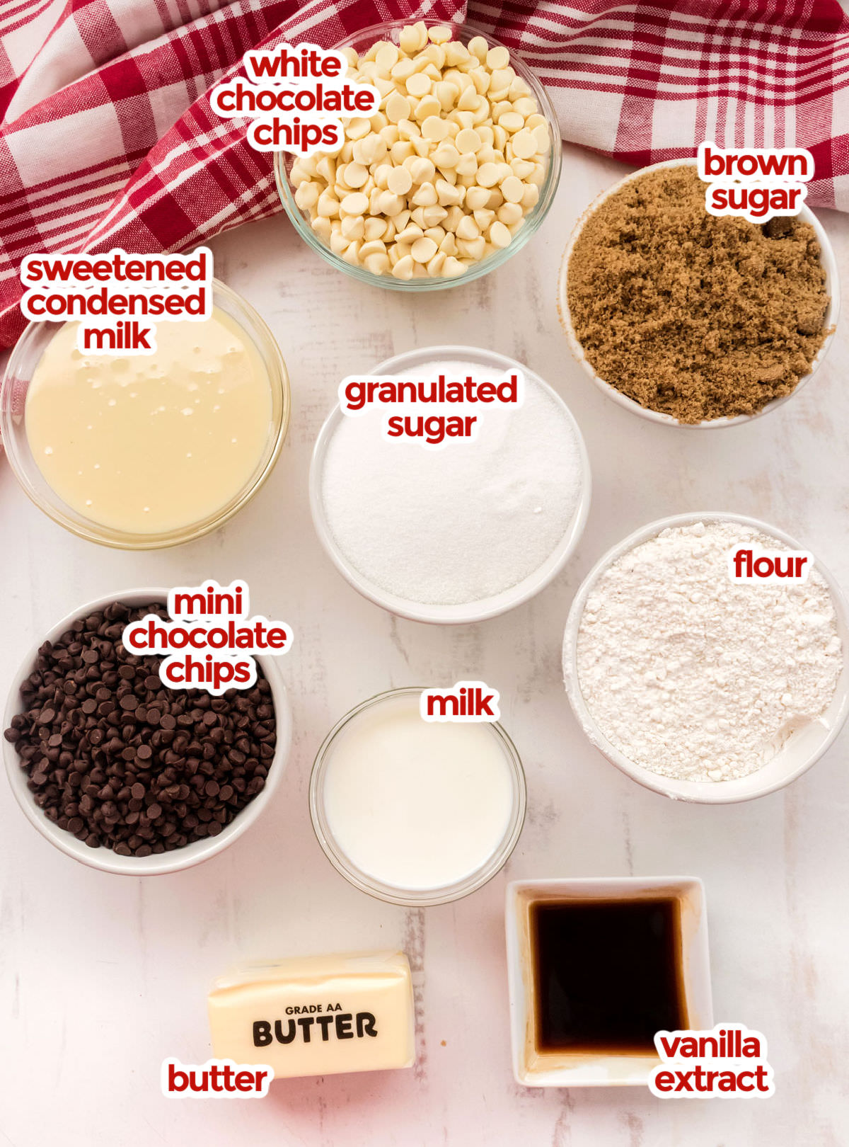 All the ingredients you will need to make Cookie Dough Fudge including White Chocolate Chips, Brown Sugar, Granulated Sugar, Sweetened Condensed Milk, Flour, Milk, Butter, Vanilla and Mini Chocolate Chips.