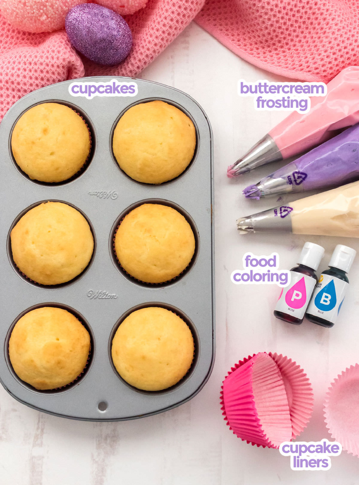 All the ingredients you will need to make Easter Cupcakes including cupcakes, purple, pink and white frosting, food coloring and cupcake liners.