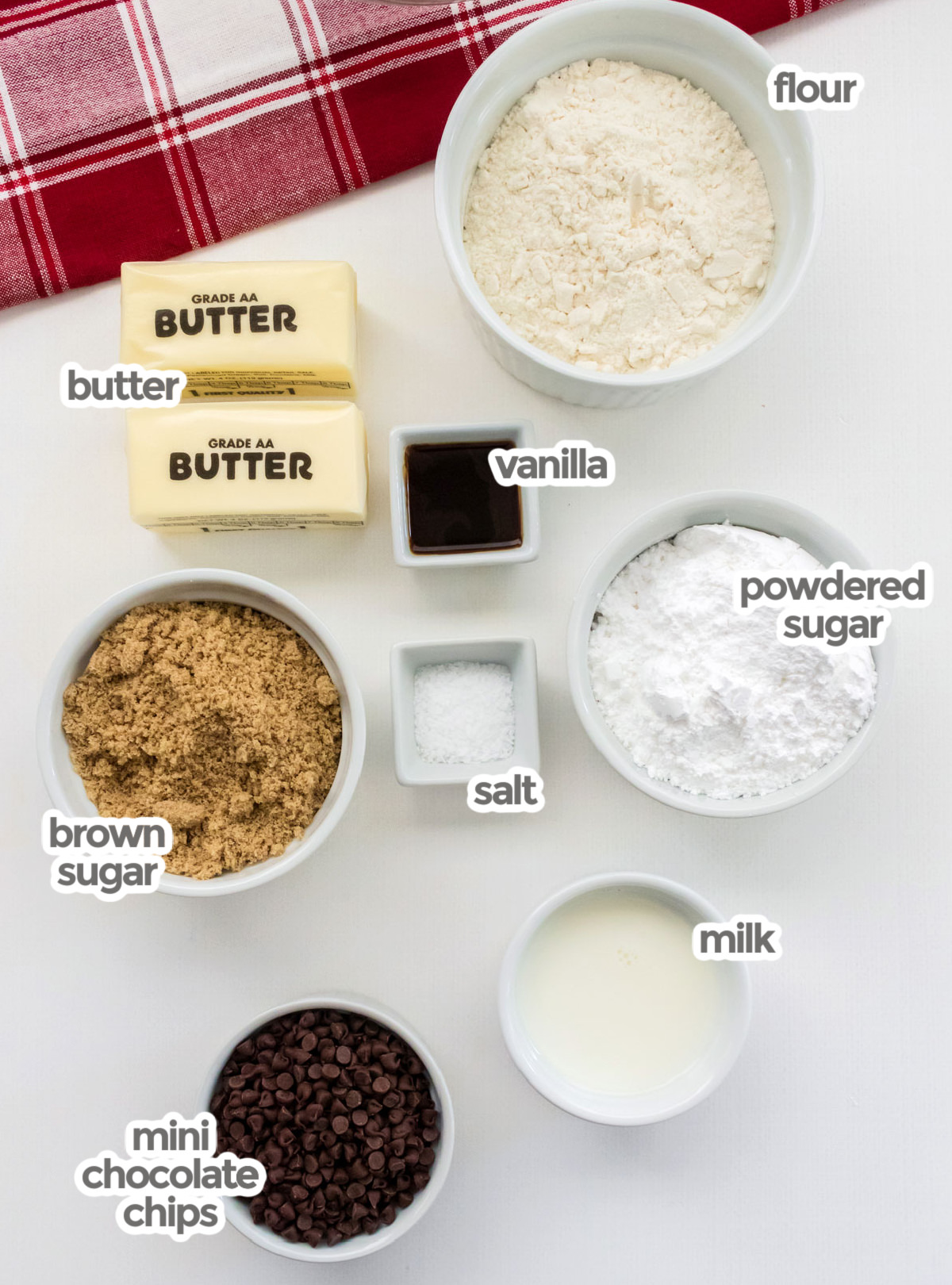 All the ingredients you will need to make Edible Cookie Dough including flour, butter, vanilla, powdered sugar, brown sugar, milk and Mini Chocolate Chips.