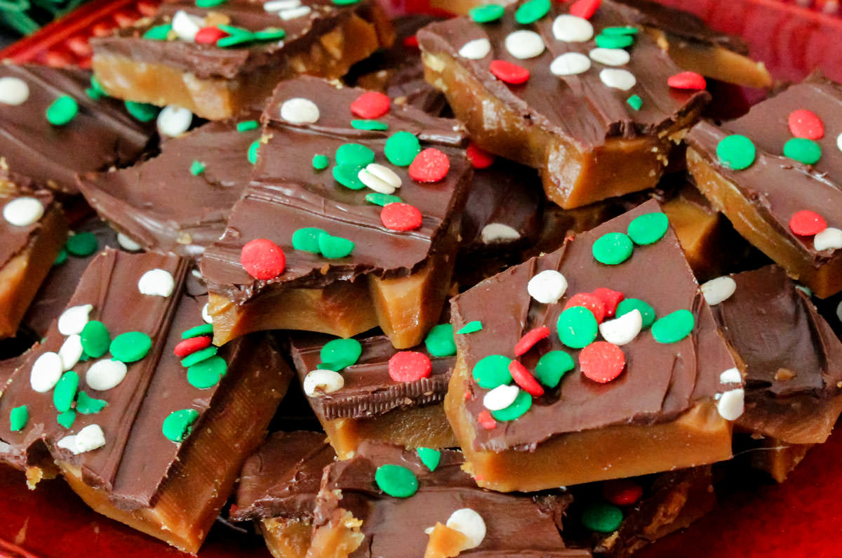 Closeup on a red plate filled with Homemade English Toffee.