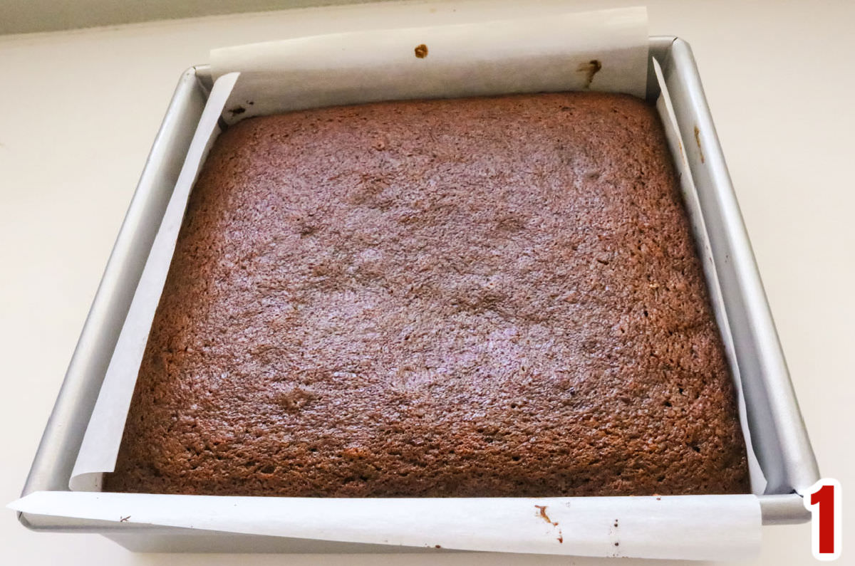 Closeup on a 8x8" square baking pan filled with Gingerbread Cake.