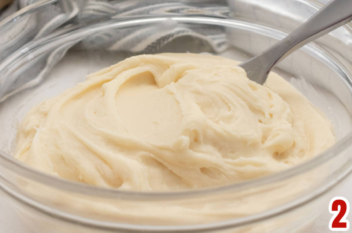 Closeup on a glass bowl filled with homemade Cream Cheese Frosting.