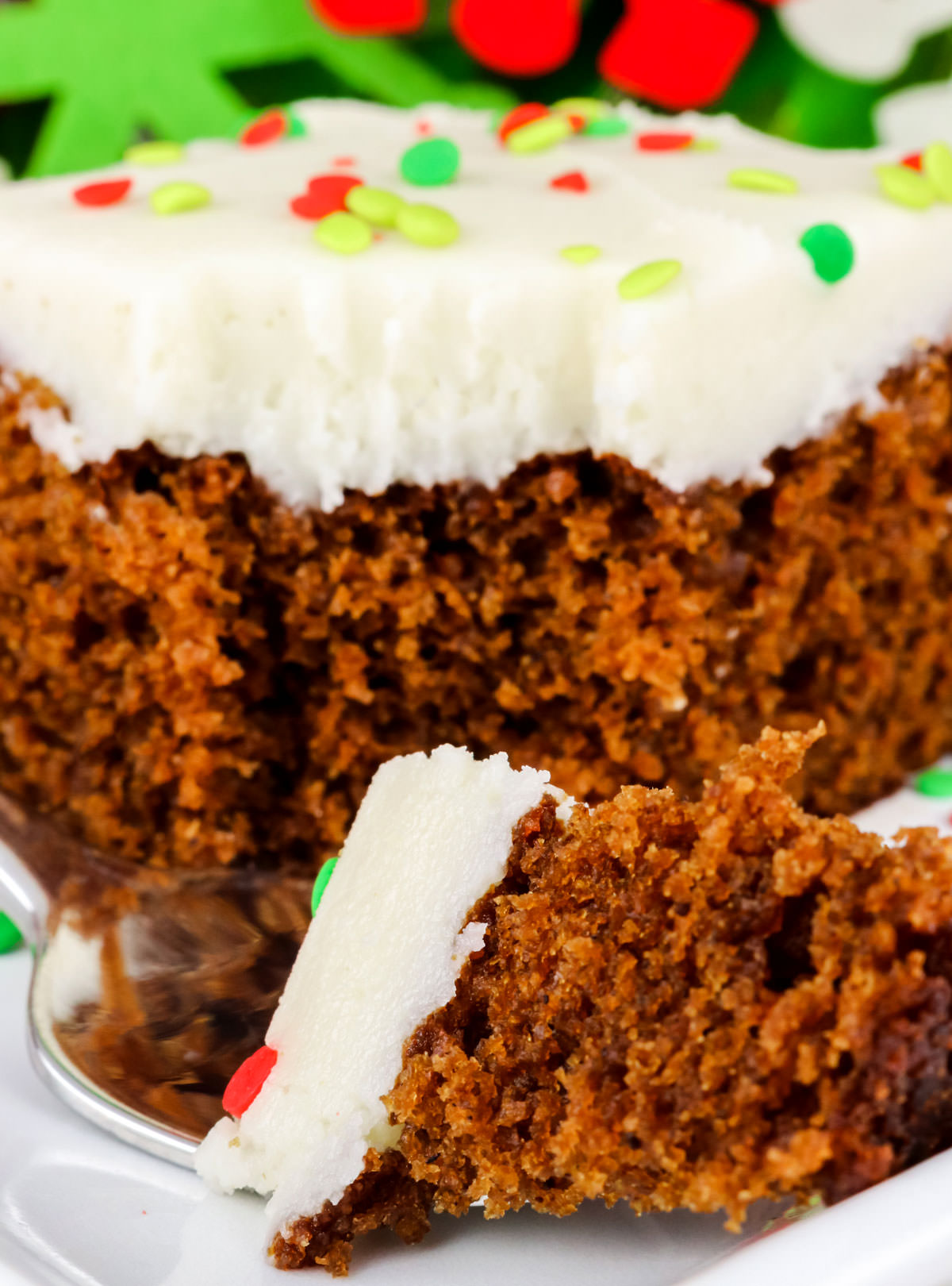 Closeup on a piece of homemade Gingerbread Cake with a piece on a fork in front of the cake.