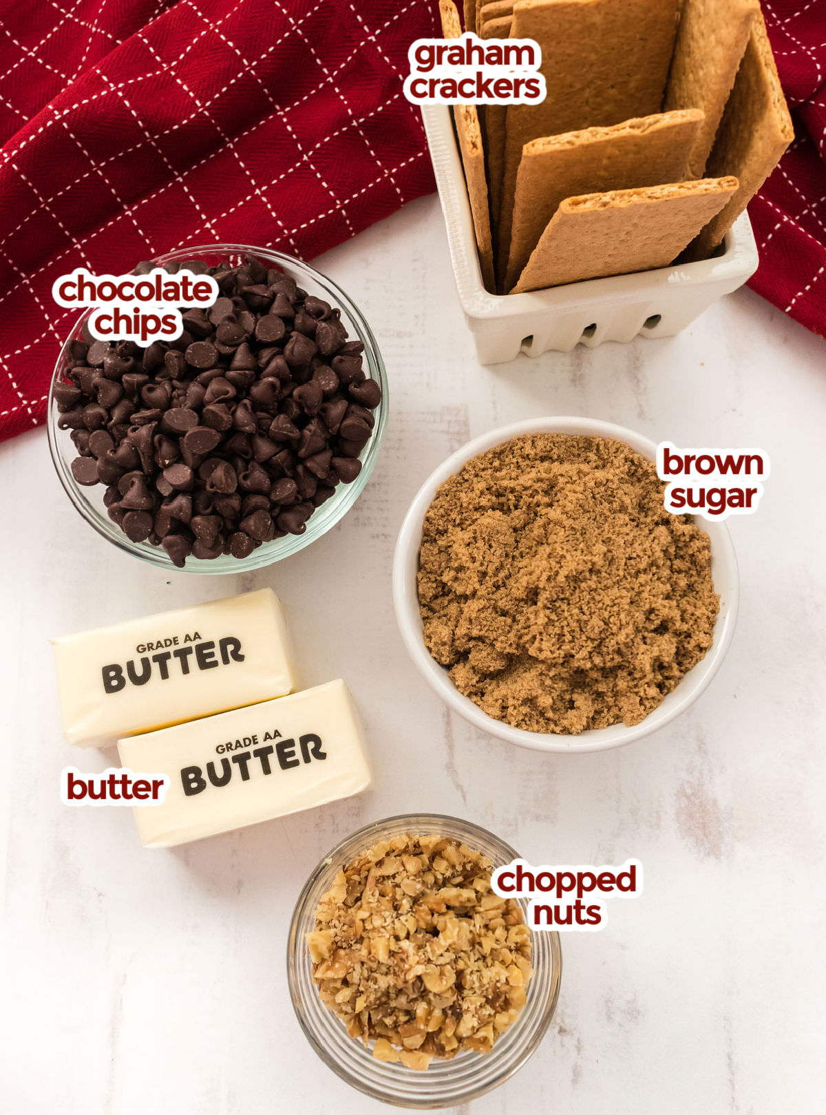 All the ingredients you will need to make Graham Cracker Toffee including Graham Crackers, Chocolate Chips, Brown Sugar, Butter and Chopped Nuts.