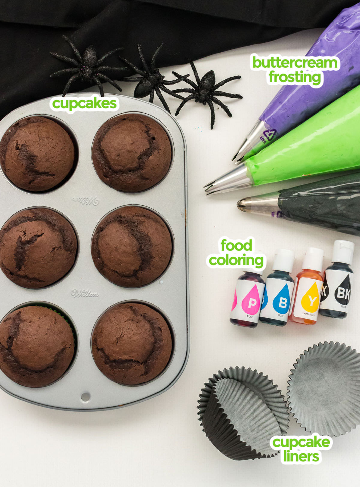 All the ingredients you will need to make Bewitched Halloween Cupcakes including cupcakes, buttercream frosting, food coloring and cupcake liners.