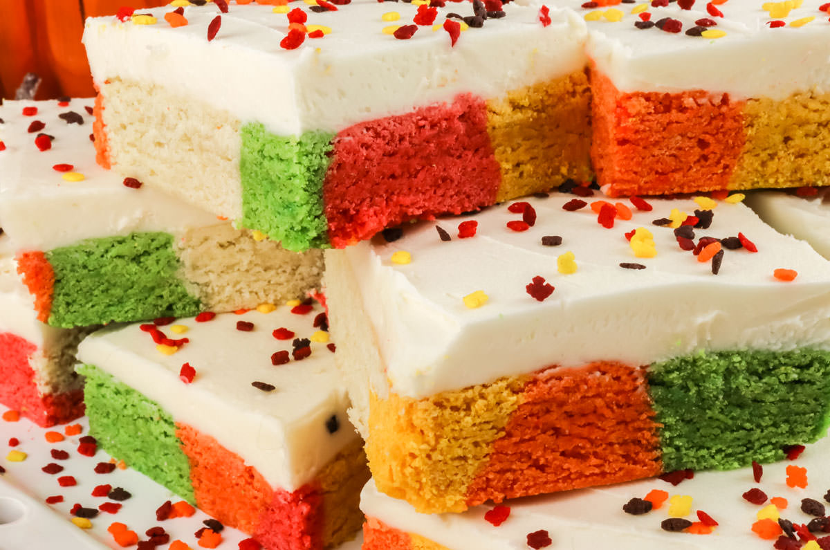 Closeup on a plate of Harvest Marble Sugar Cookie Bars surrounded by Fall sprinkles.