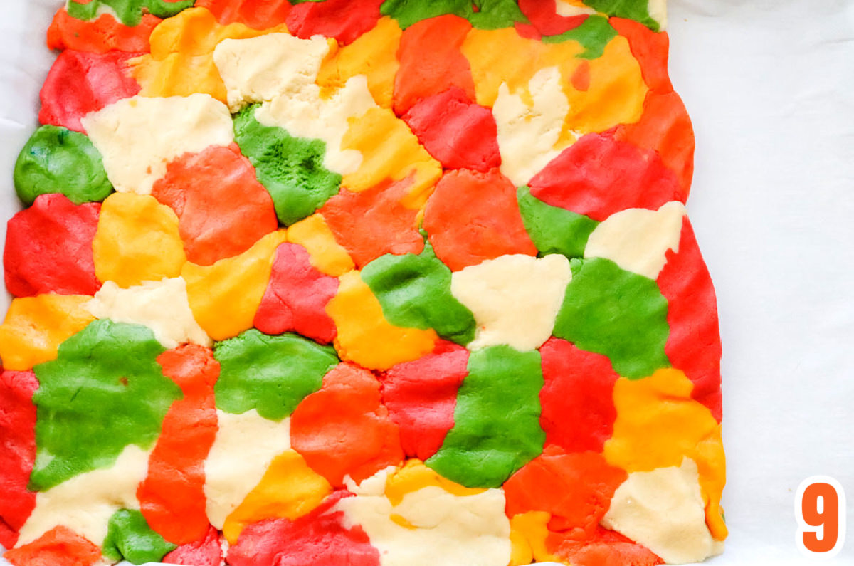 Marbled Sugar Cookie dough pressed into a cookie sheet covered with parchment paper.