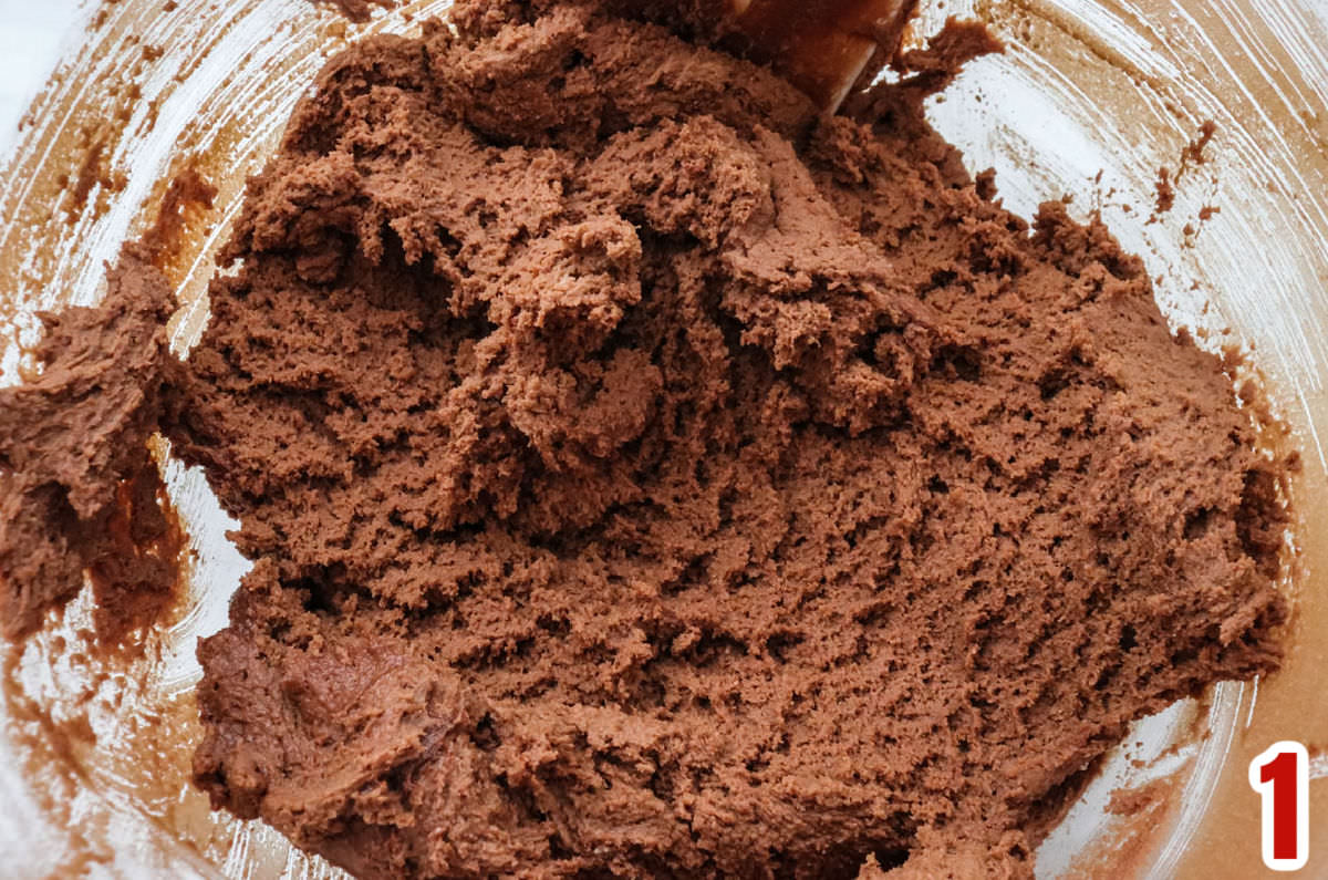 Closeup on a glass bowl filled with chocolate cookie dough.