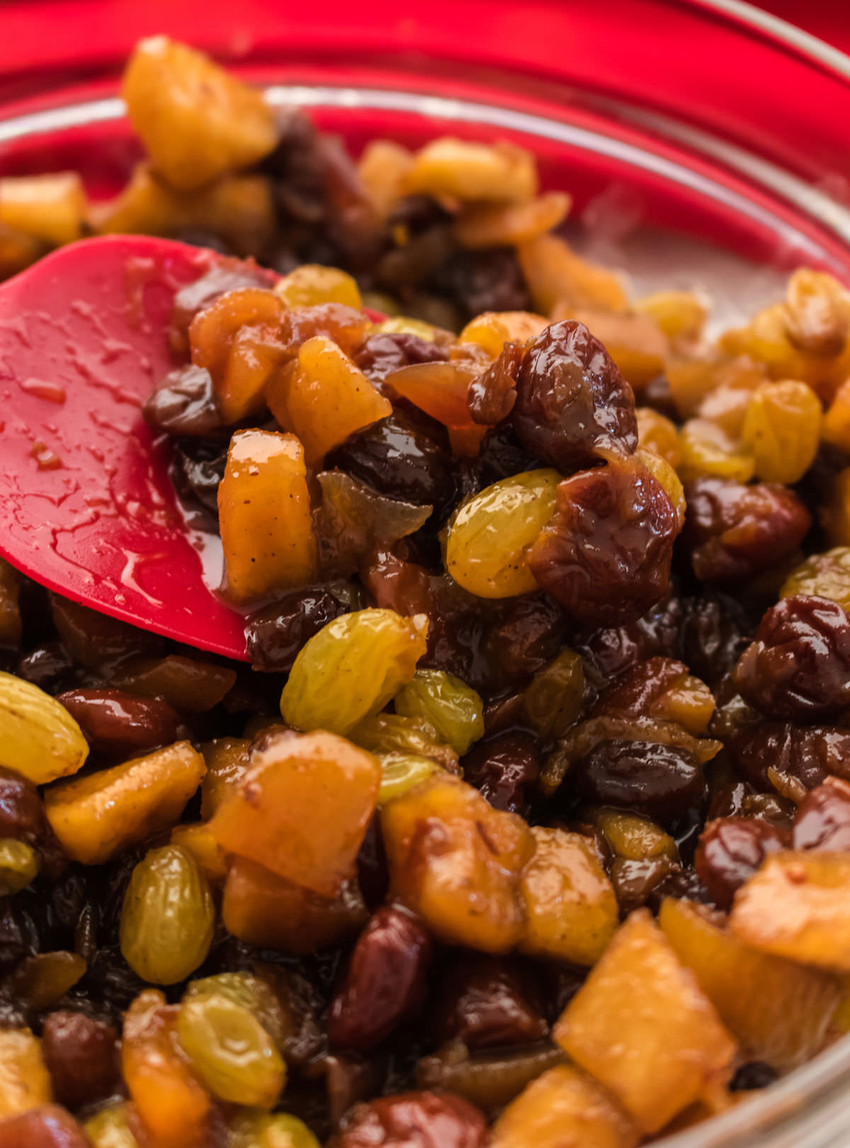 bowl of homemade mincemeat in a glass bowl with a red spoon