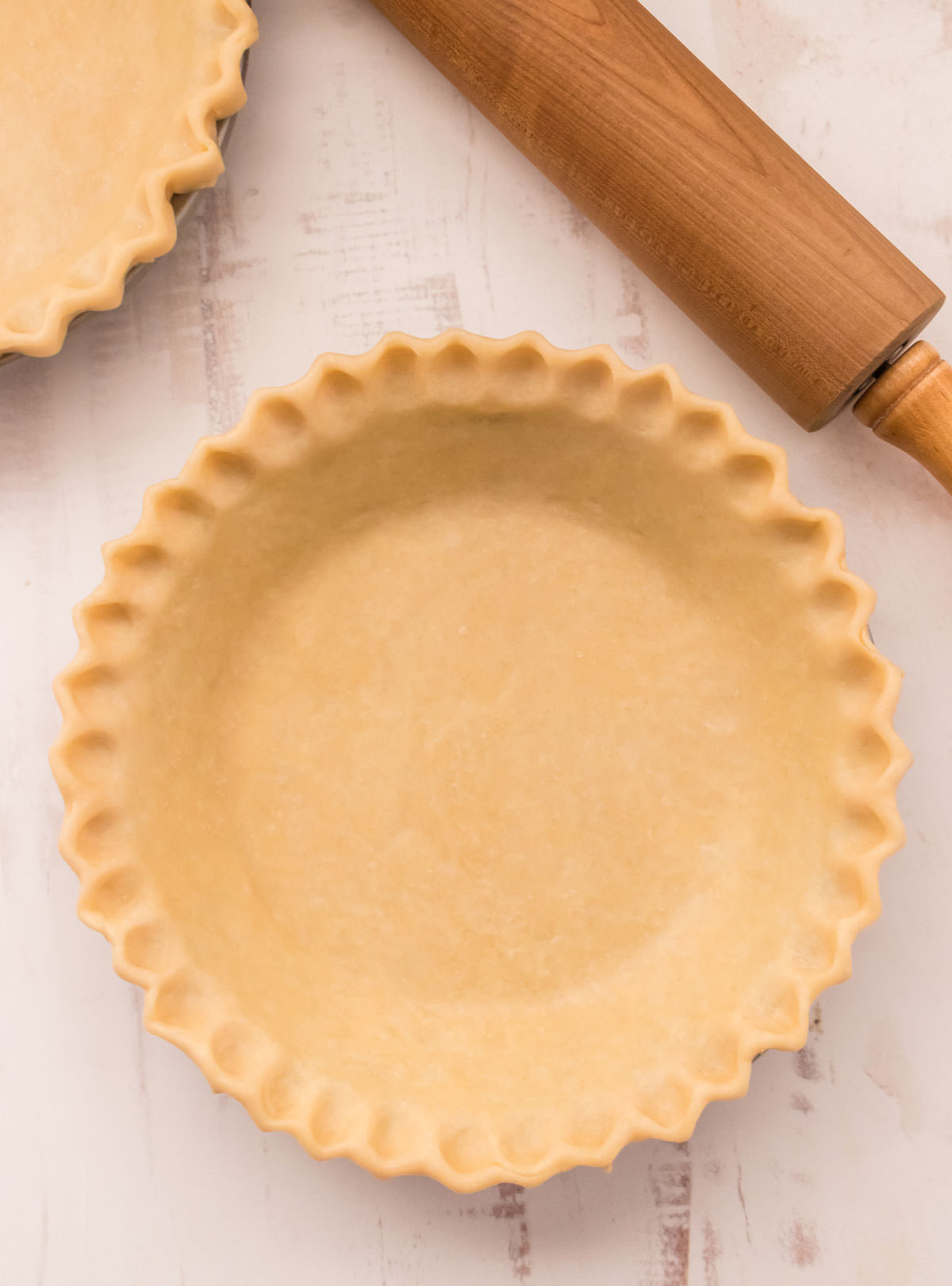 Picture of a pie crust reading to be filled and go in the oven.