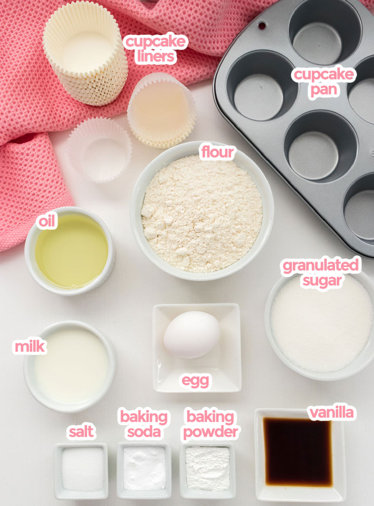 Ingredients needed to make Homemade Vanilla cupcakes including flour, sugar, oil, milk, egg, vanilla, baking powder, baking soda and salt.