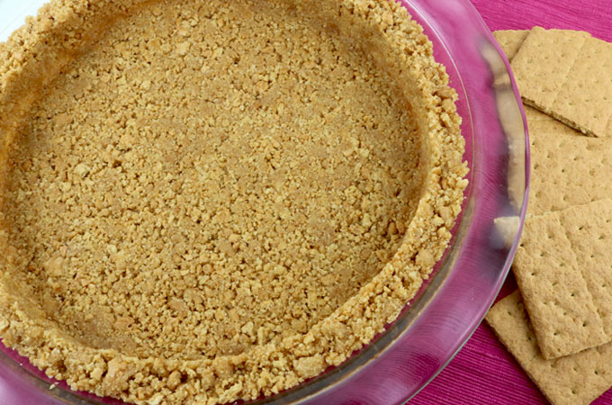 We show you How to Make Graham Cracker Crusts that are super easy to make, can be bake or no-bake and taste better than anything you can buy in the store. This is the Best Graham Cracker Crust recipe that you are going to find. Pin this Perfect Graham Cracker Crust recipe for later and follow us for more pie crust recipe ideas.