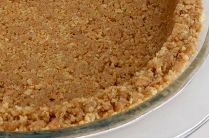 We show you How to Make Graham Cracker Crusts that are super easy to make, can be bake or no-bake and taste better than anything you can buy in the store. This is the Best Graham Cracker Crust recipe that you are going to find. Pin this Perfect Graham Cracker Crust recipe for later and follow us for more pie crust recipe ideas.
