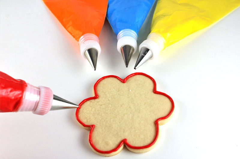 Learn How to Make Royal Icing - it's easier than you might think! This is a quick and easy recipe for Royal Icing that we use again and again for decorating cookies. Pin this easy Royal Icing recipe for later and follow us for more yummy Frosting Recipes #RoyalIcing #RoyalIcingRecipe #Frosting #Icing
