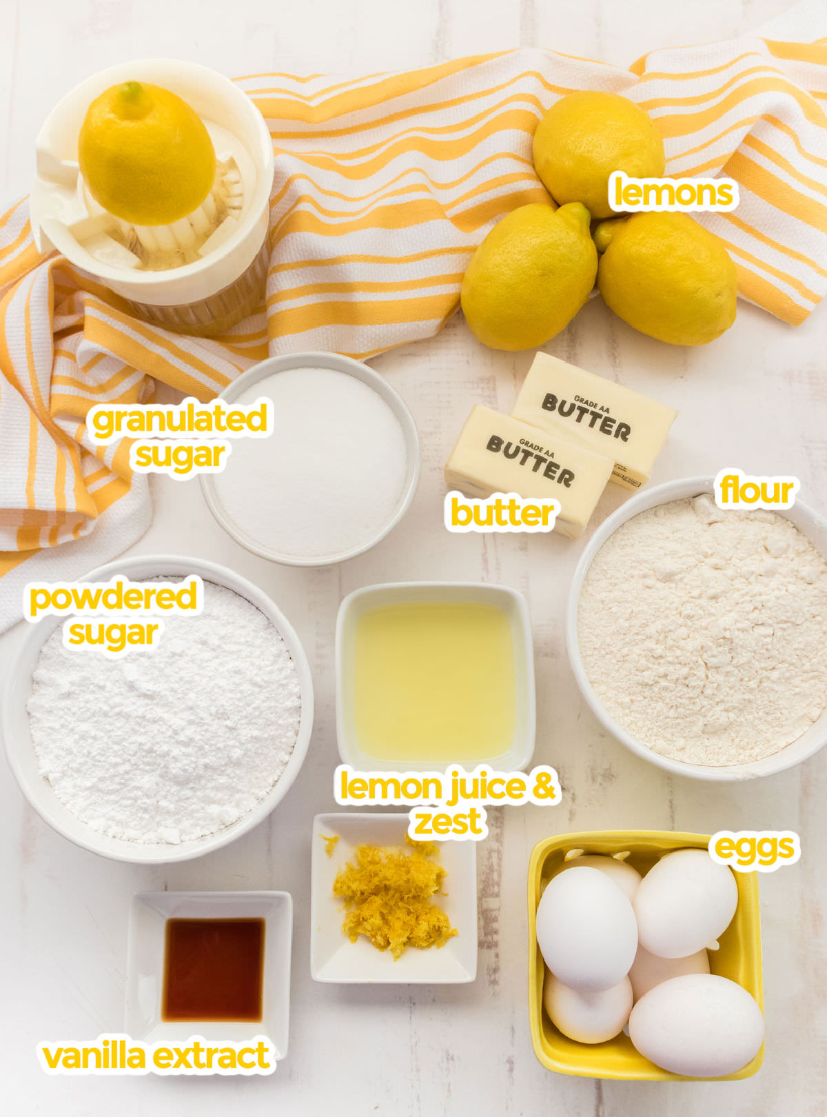 All the ingredients you will need to make Lemon Pound Cake including lemons, butter, granulated sugar, flour, powdered sugar, lemon juice and zest, eggs and vanilla.