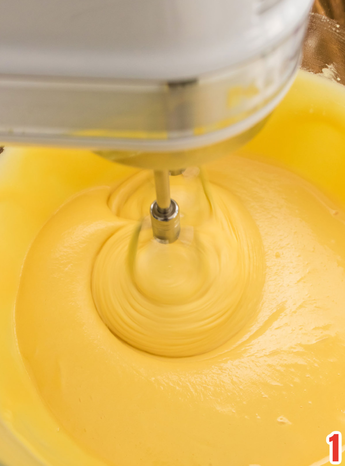Closeup on the Christmas Mini Bundt Cake batter being mixed with a handmixer.