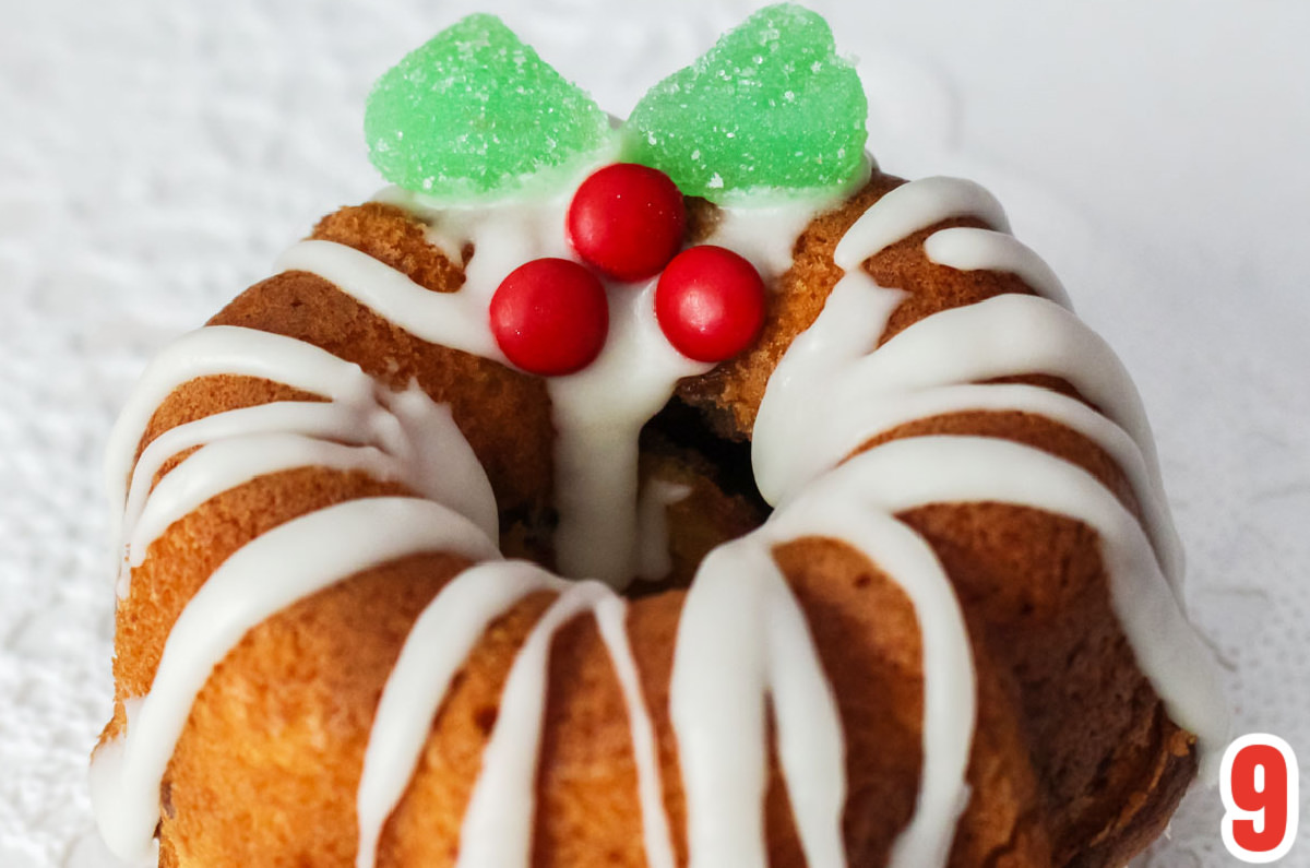 Closeup on the candy Holly Berry decoration on the top of the Christmas Mini Bundt Cake.