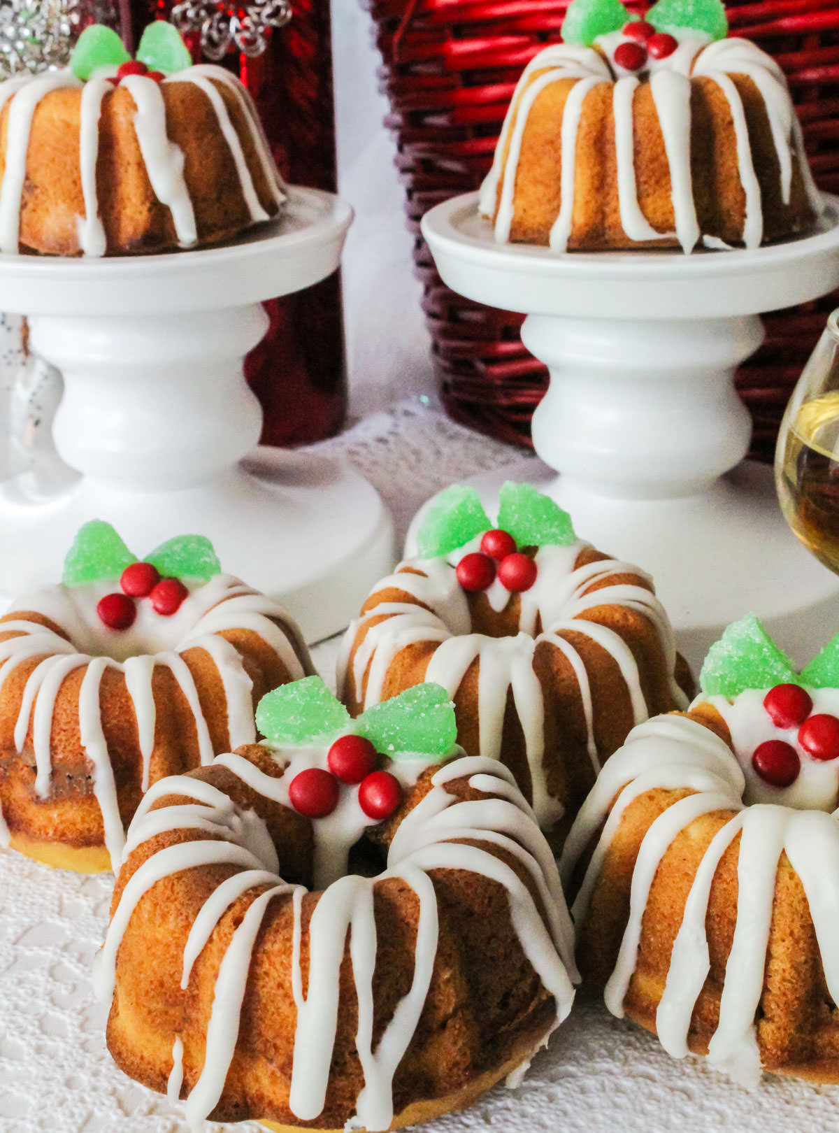 Six Christmas Mini Bundt Cakes sitting on a white table.