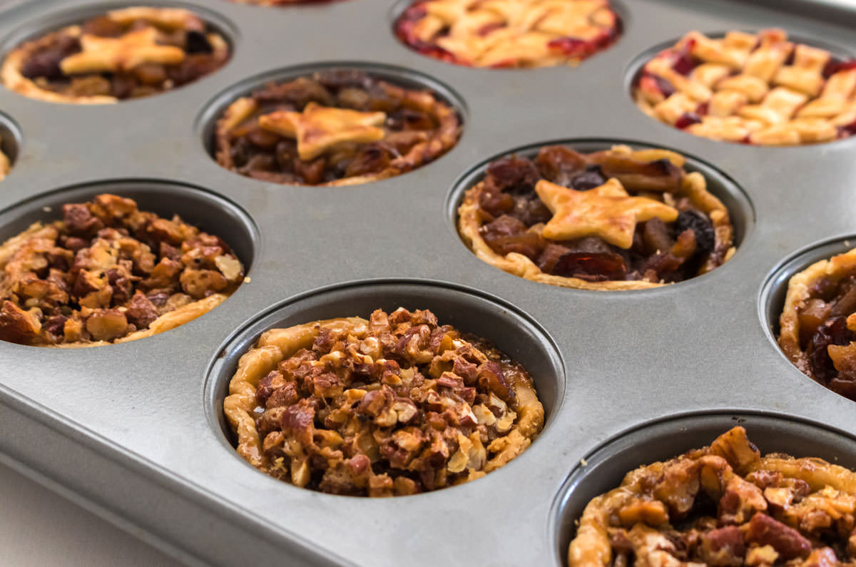 Closeup on a muffin tin filled with three different flavors of Mini Pies.
