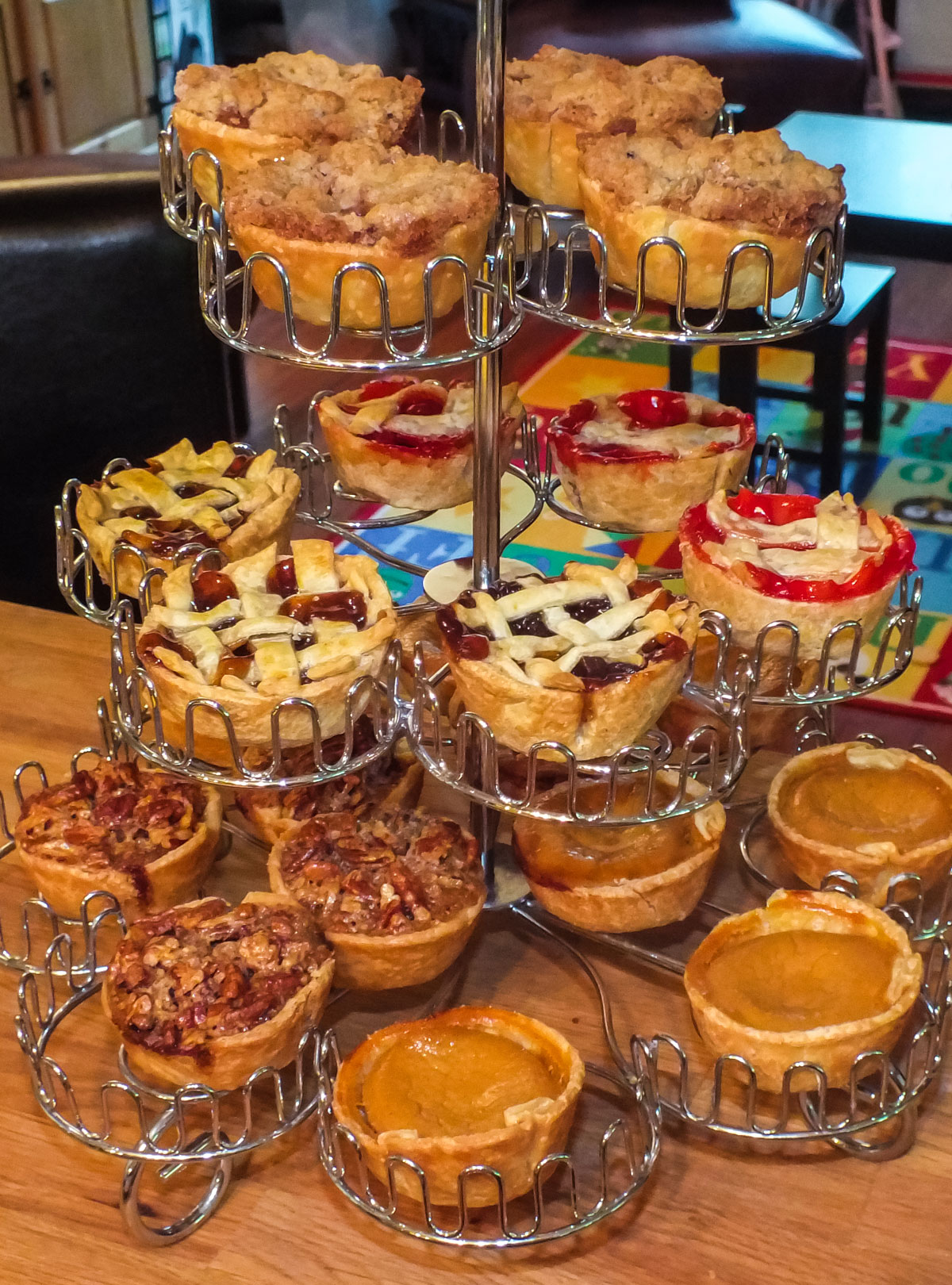 Closeup on a Cupcake Stand filled with Mini Pies for the Holidays of various flavors including Mince, Cherry, Pecan, Pumpkin and Apple.