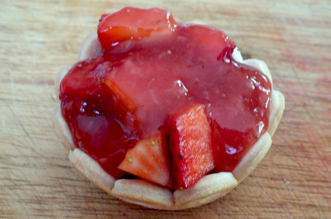 Add spoonful of strawberry glaze over strawberries