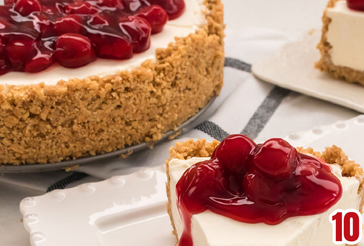 Closeup on the cherry pie filling topping on a no bake cheesecake.