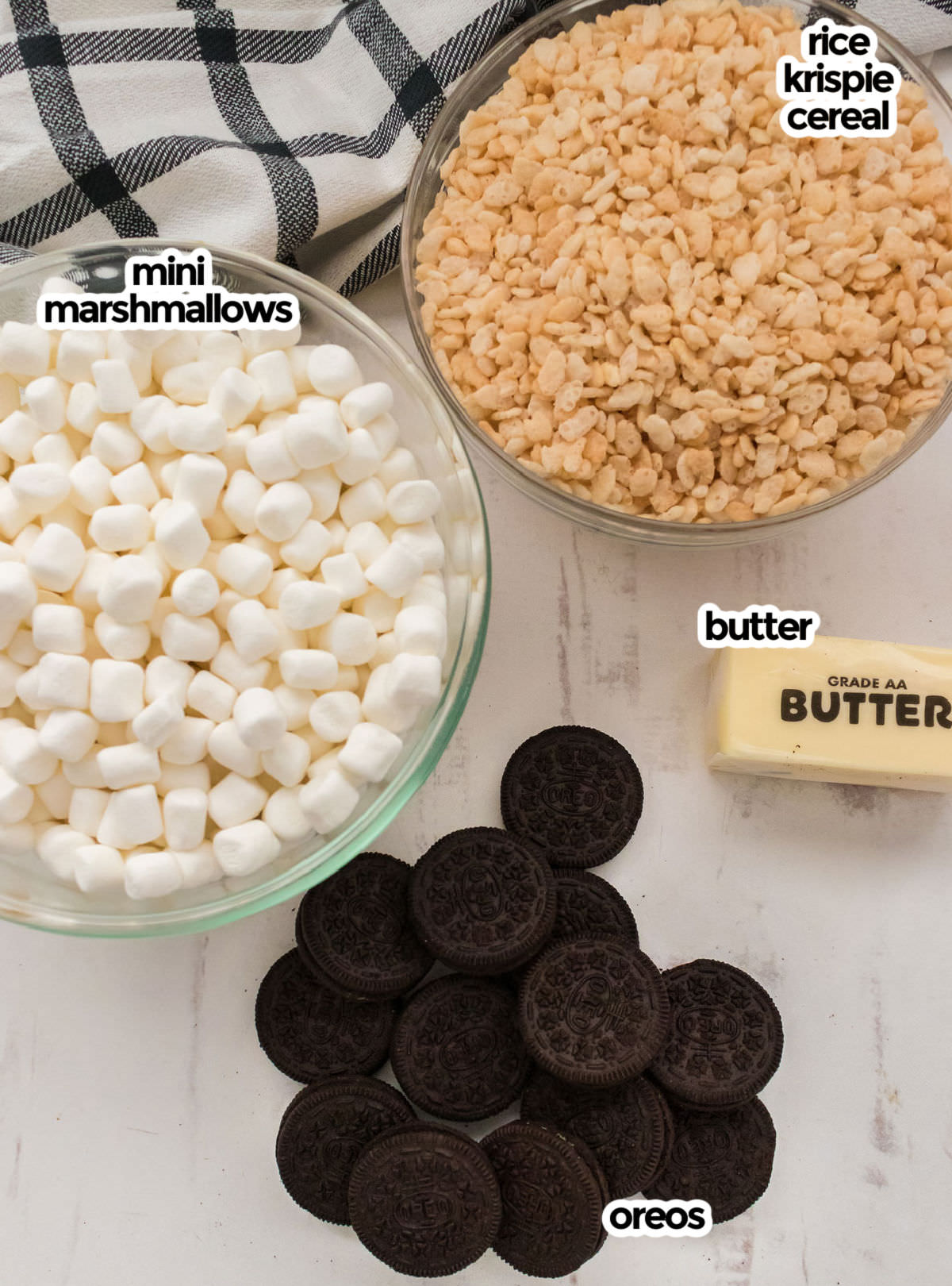 All the ingredients you will need to make Oreo Rice Krispie Treats including Mini Marshmallows, Rice Krispie Cereal, Butter and Oreo Cookies.